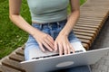 A young girl types on the keyboard of a laptop, computer.