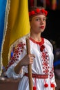 Young girl Ukrainian dancer in traditional costume, with national flag