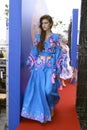 Young girl in Ukrainian national embroidered dress posing in front of a crowd of people. Celebration of Embroidered