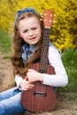 Young girl with ukulele Royalty Free Stock Photo