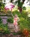 Young girl with umbrella in hand, on the stairs, which meets the bright, blue smoke.