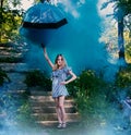 Young girl with umbrella in hand, on the stairs, which meets the bright, blue smoke.