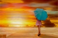 Young girl with umbrella stand alone near the sea Royalty Free Stock Photo