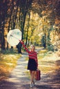 Girl with umbrella and suitcase in autumn park Royalty Free Stock Photo