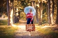 Girl with umbrella and suitcase in autumn park Royalty Free Stock Photo