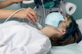 young girl undergoes ultrasound of thyroid gland. patient wearing mask. thyroid gland produces hormones that affect your