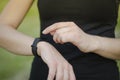 A young girl uses a fitness tracker. Smartwatch. Royalty Free Stock Photo