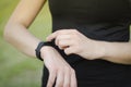 A young girl uses a fitness tracker. Smartwatch. Royalty Free Stock Photo