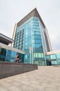 Young girl uses a smartphone on the office building background