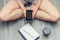 Young girl using her mobile phone for messaging while having a r Royalty Free Stock Photo