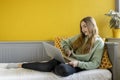 Young girl using laptop on her bed Royalty Free Stock Photo