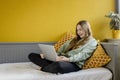 Young girl using laptop on her bed Royalty Free Stock Photo