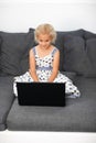 Young girl using a laptop at home Royalty Free Stock Photo