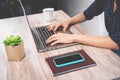 Young girl using laptop at home - Side view female hands typing on computer working on digital marketing Royalty Free Stock Photo