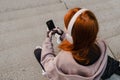 Young girl using mobile phone while sitting outdoors Royalty Free Stock Photo