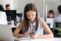 Young girl using mobile phone at workplace, prepare make call Royalty Free Stock Photo