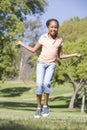 Young girl using skipping rope outdoors smiling Royalty Free Stock Photo