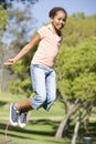 Young girl using skipping rope outdoors smiling Royalty Free Stock Photo