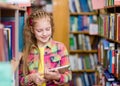 Young girl using a tablet computer in a library Royalty Free Stock Photo