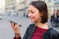 Young girl using vocal assistant on smart phone Royalty Free Stock Photo