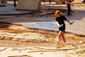 A young girl wades in a scale model of the Mississippi River