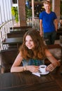 Young girl waiting for a boyfriend in cafe