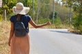 Beautiful girl hitchhiking. Cheapest way to travel. Woman tourist in Asia.