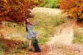 Young girl waiting on a country road with her suitcase. Royalty Free Stock Photo