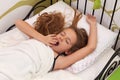 Young girl waking up in her bed Royalty Free Stock Photo