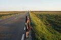 A young girl is walking along the road. She looks around. Royalty Free Stock Photo