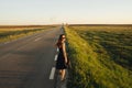 A young girl is walking along the road. She looks around. Royalty Free Stock Photo