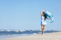 Young girl walking on the beach with blue scarf Royalty Free Stock Photo