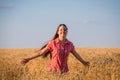 Young girl walking on field with ripe wheat Royalty Free Stock Photo