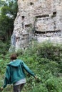 young girl walking in the jungle to visit funerary tau tau effigies and cave cemetery in tana toraja, sulawesi