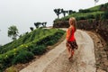 Young girl walking in a pasture or prairie on a rainy cloudy day