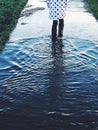 Young Girl Walking through Puddle