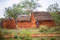 Young girl walking in traditional african village, Kenya