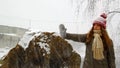 Young girl walking in winter snow falls