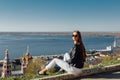 A young girl walks on the embankment of the city bay.