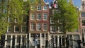 Young girl walks over footbridge on Brouwersgracht Canal in Amsterdam