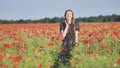 A young girl walks through a red poppy field. Royalty Free Stock Photo