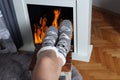 Embracing Winter Comfort: Young Woman Finds Warmth and Coziness by the Fireplace Royalty Free Stock Photo