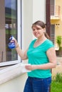 Young girl washing windows outside Royalty Free Stock Photo