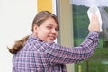 Young girl washing windows outside Royalty Free Stock Photo