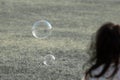 A young girl watching bubbles float and fly in the air. Royalty Free Stock Photo