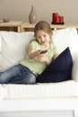 Young Girl Watching Television at Home Royalty Free Stock Photo