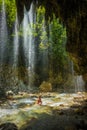 Young girl in waterfall near Panta Vrexei in Evritania, Greece