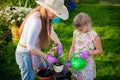 Young girl watering potted flower plant smiling Royalty Free Stock Photo