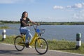 Young girl wear black shirt and jean bike yellow bicycle on the road