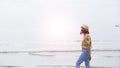 Young girl wear hat and colorful shirt walkking at beach Royalty Free Stock Photo